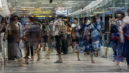 Crowd of people moving fast, long exposure time lapse, modern densely populated city, asia bangkok thailand photo