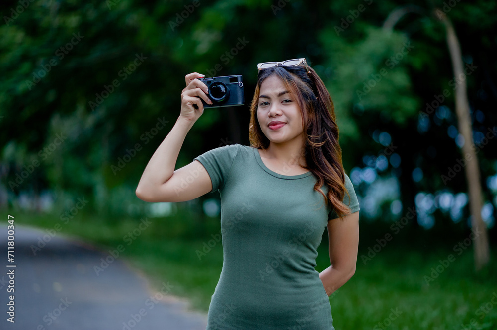 Beautiful Asian tourist and her personal camera female photographer Surround Milleles