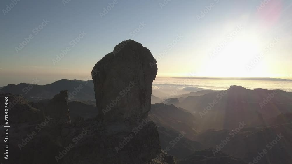 Aerial view of Roque Nublo and Mar de Nubes at sunset in the ravines of Gran Canaria (4K)
