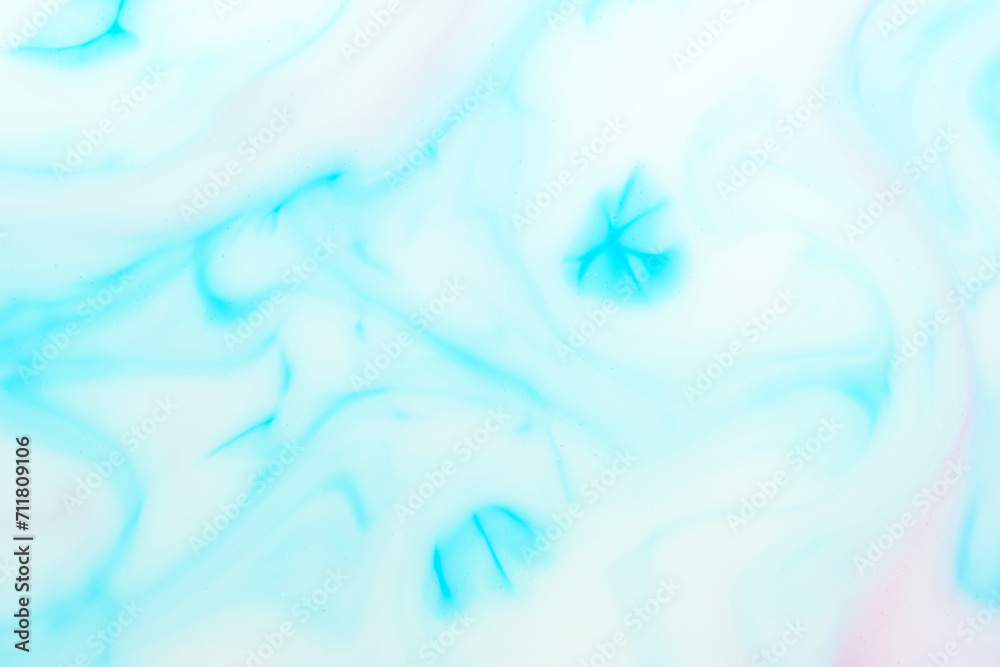 Background with blue streaks on white milk. Marble texture.