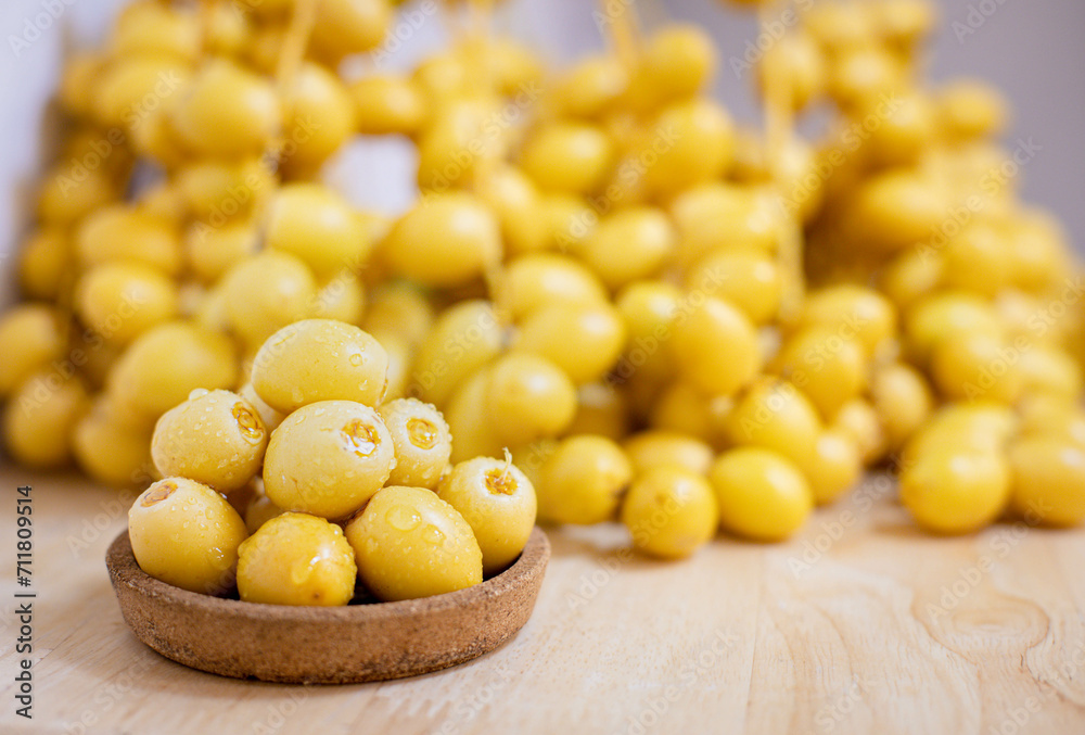 Close up and selective focus fresh dates fruits in wooden bowl.
Close up and selective focus fresh dates fruits in wooden bowl.