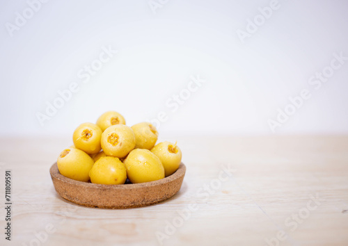 Close up and selective focus fresh dates fruits in wooden plate in copy space concept.