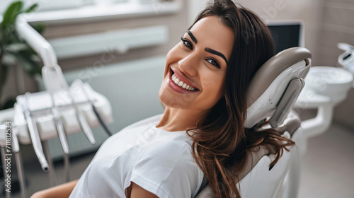 smiling brunette woman in dentist surgery having dental checkup