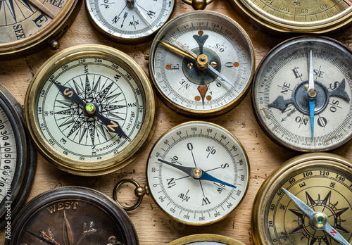 Collection, set of old compasses on the table. Travel, geography, navigation, tourism, histoory and exploration concept background. Old compass background.