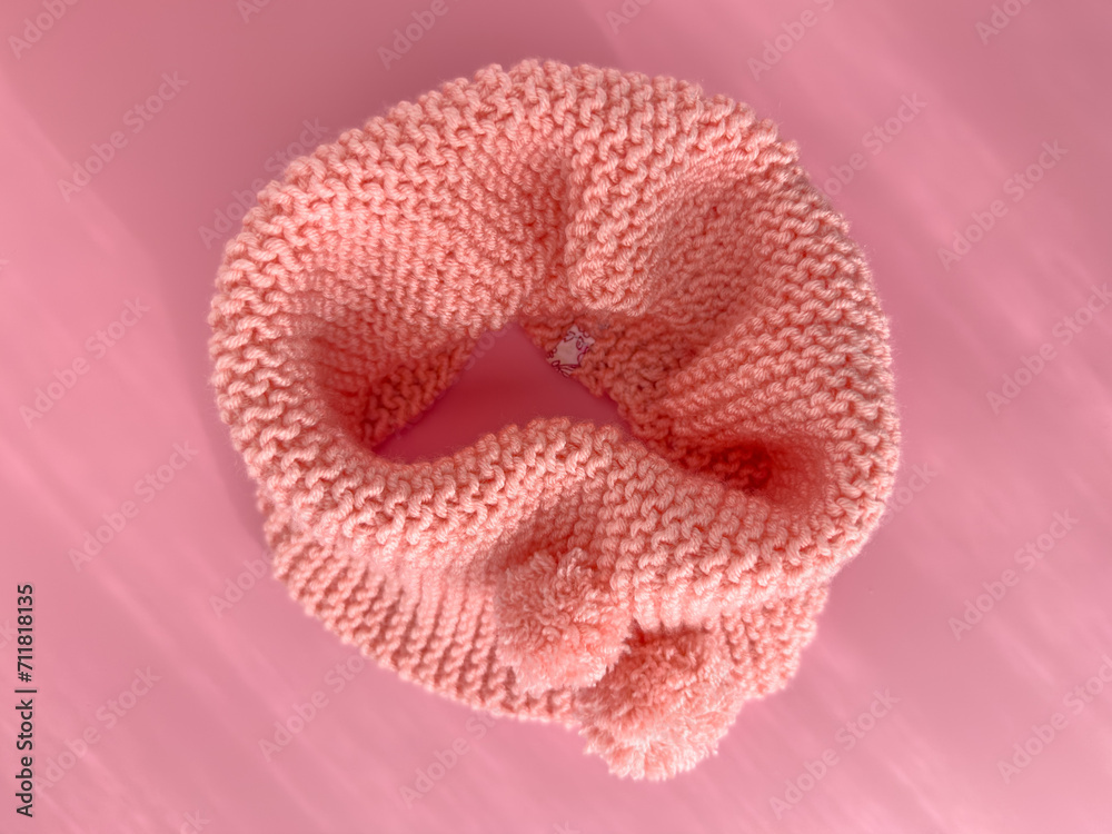 Soft pink lace knitted round scarf isolated on pastel pink background. Fashion children's accessory. Soft pink lace knitted round scarf isolated on pastel pink background. Fashion children's accessory.