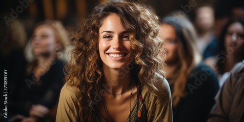A joyful woman with a warm smile and layered brown hair radiates happiness as she confidently gazes into the camera, her clothing and human face adding to her captivating presence