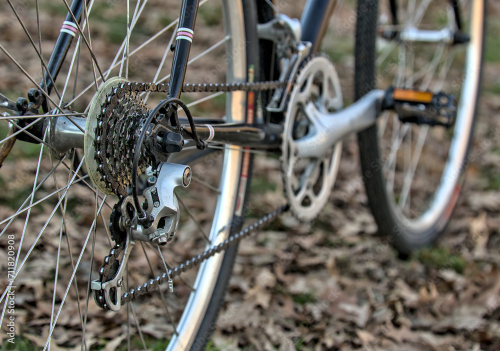 road bike drivetrain close up with rear derailleur, cassette and chain in focus (bicycle parts close up, crankset ,pedal, tire, wheel, spokes) black frame road bike drivetrain close up with rear derailleur, cassette and chain in focus (bicycle parts close up, crankset ,pedal, tire, wheel, spokes) black frame