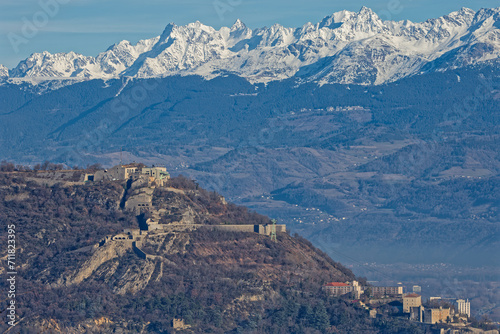 GRENOBLE, FRANCE, December 30, 2023 : Fortress of La Bastille over Grenoble and Belledonne mountain range landscape, where Prapoutel ski resort can be seen on the slopes.