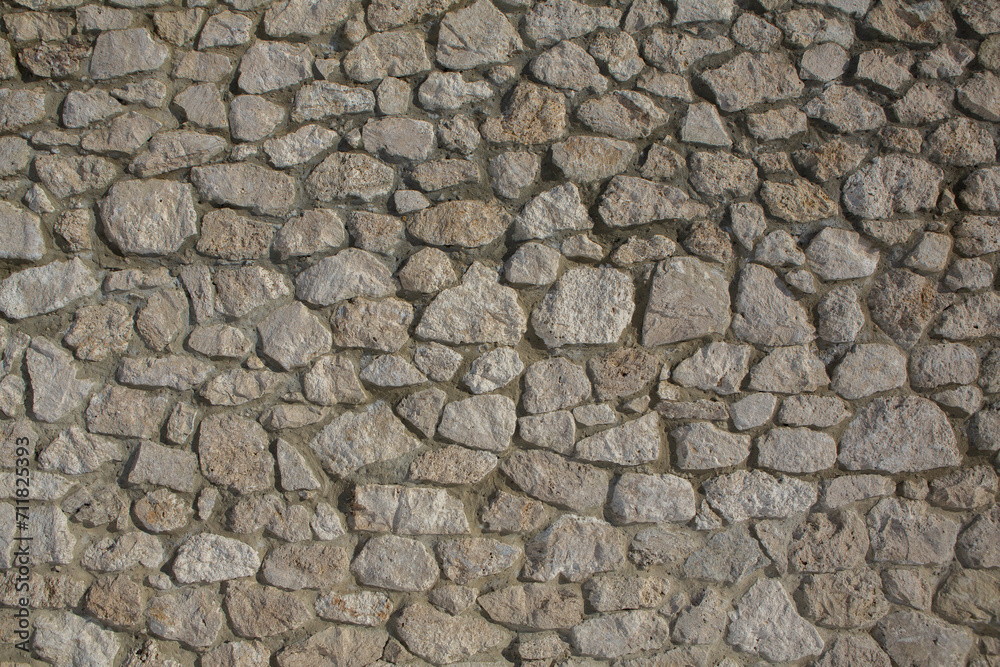 Background of stone wall texture photo. Close-up of stone wall. Background of stone wall texture photo. Close-up of stone wall.