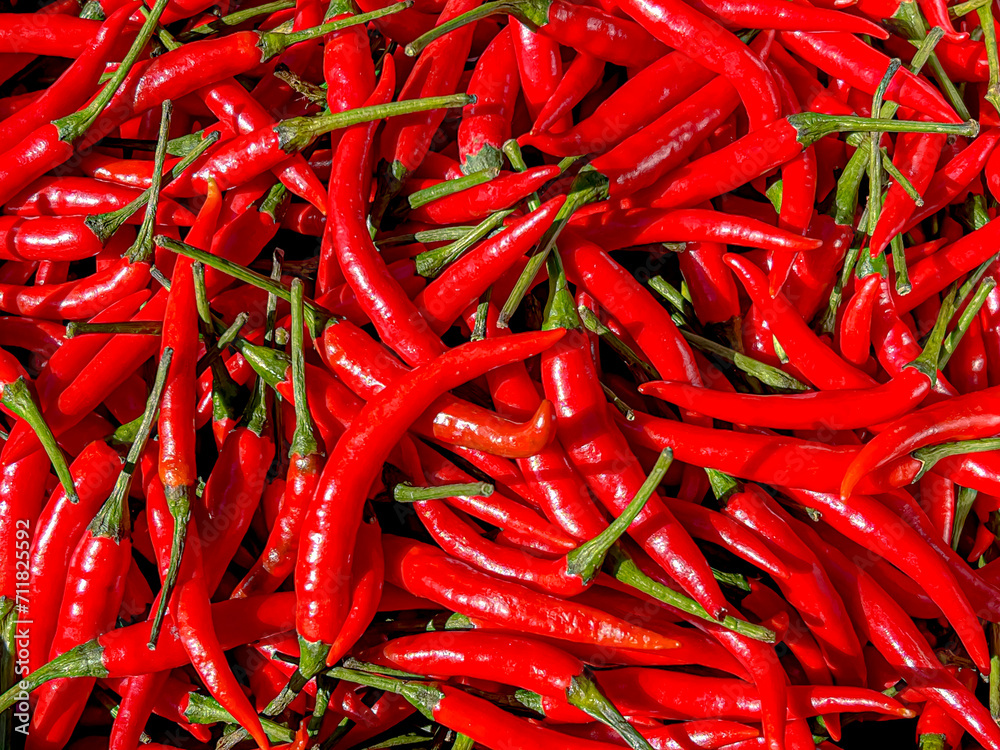 Red hot chili texture background, Pile of fresh and ripe chili pepper, It is used extensively in Thai, Malaysian, Singaporean, Lao, Khmer, Indonesian, Kerala and Vietnamese cuisines.