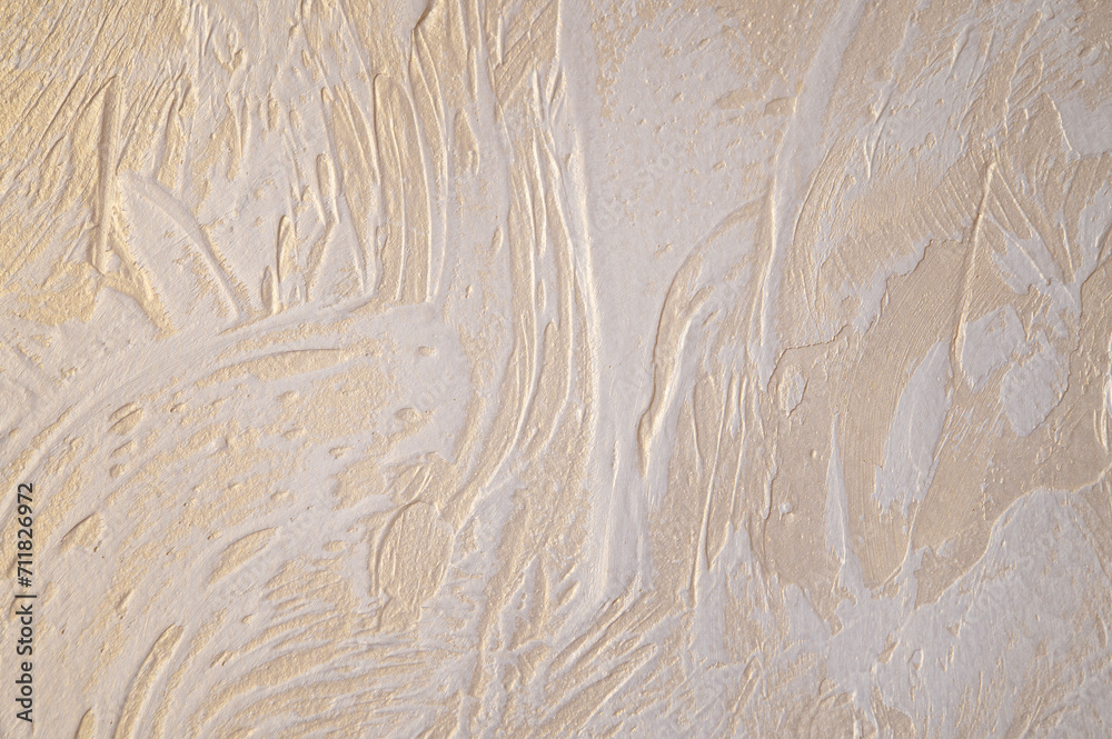 Wall with decorative plaster. Gold glossy plated with white relief pattern. Wall with decorative plaster. Gold glossy plated with white relief pattern.
