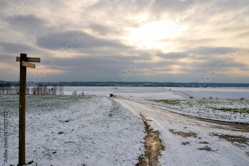 A magnificent winter scene with a snowy landscape in the countryside with an icy and snowy path.