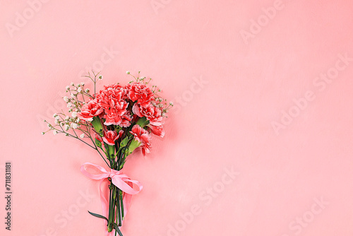 Floral arrangement with carnations on a pink background. Concept for Valentine's Day or Women's Day, Mother's Day, banner, greeting your loved one on holiday, birthday,