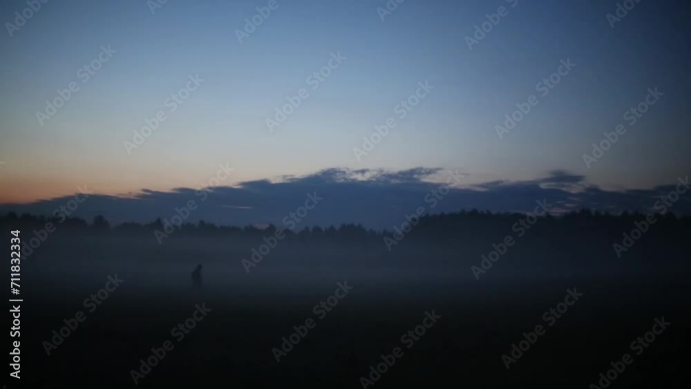 Two people go on beautiful valley in fog at morning Two people go on beautiful valley in fog at morning