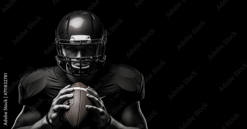 Black and white photography of an American football player holding rugby ball on a black background with copy space design