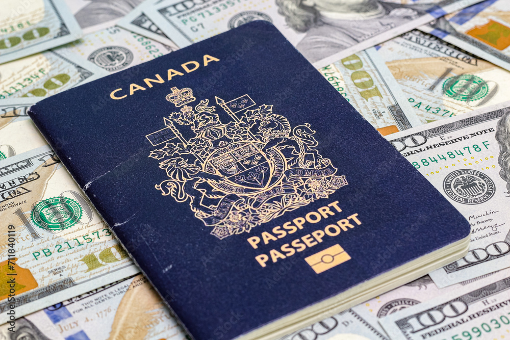 Closeup view of canadian passport and us dollar banknotes. Closeup view of canadian passport and us dollar banknotes.