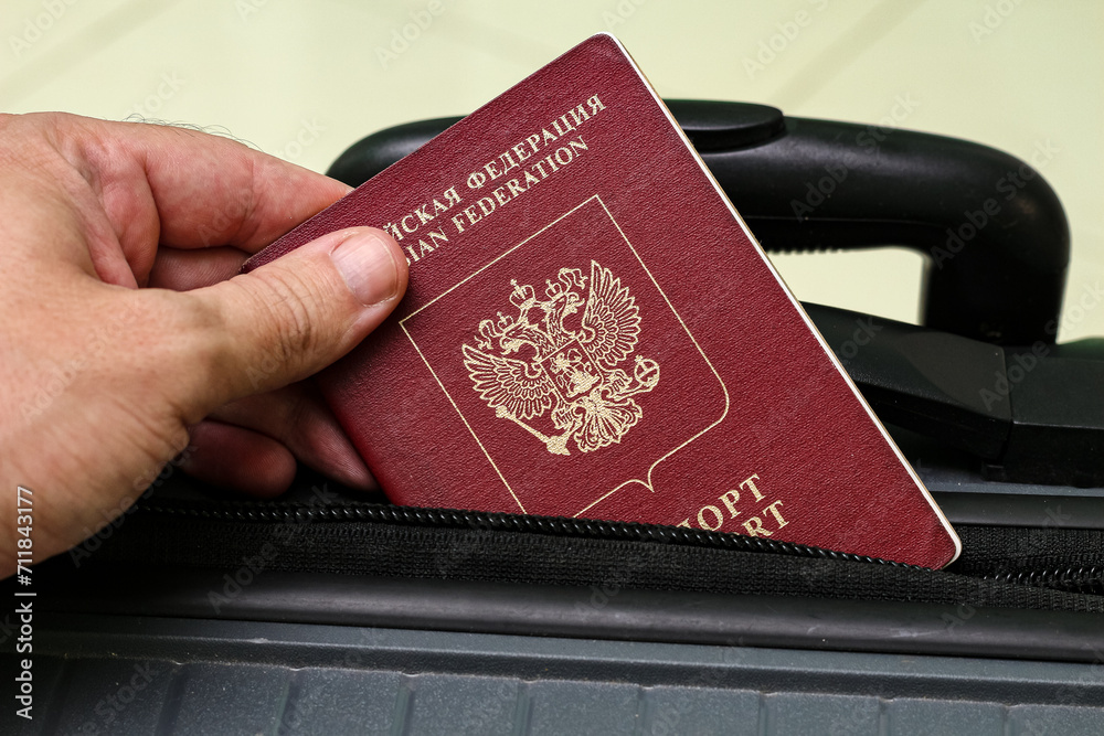 Closeup view of russian passport and grey suitcase. Closeup view of russian passport and grey suitcase.