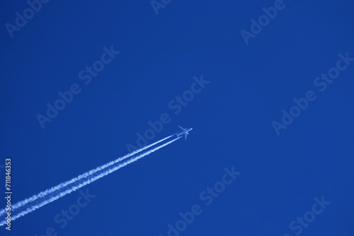 airplane trail in the clear blue sky photo