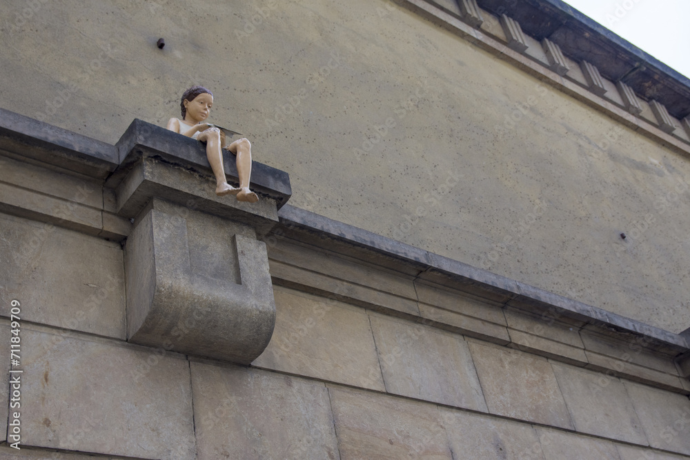 Symbol of Prague, a girl sitting on a wall Symbol of Prague, a girl sitting on a wall