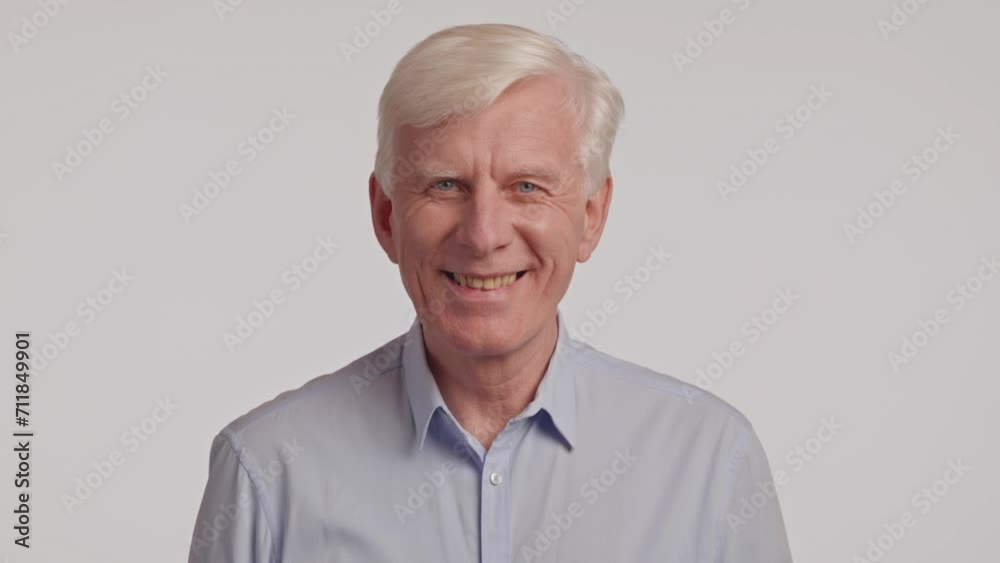 gray-haired adult man looking at the camera and smiling on a white background gray-haired adult man looking at the camera and smiling on a white background