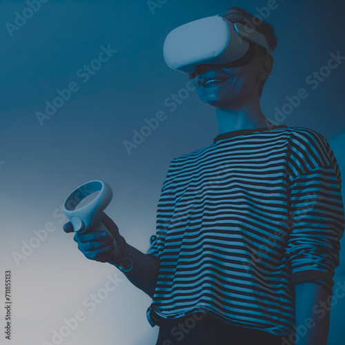 woman wearing headsets of virtual reality standing on orange background looking away