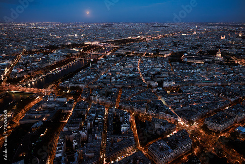 Paris city at night from above. Aerial view from Eiffel tower at blue hour. Panorama skyline after sunset. Full moon night at Capital of France © Girts
