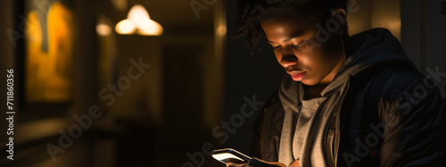 Young mobile phone addict man awake at night using smartphone for chatting, flirting and sending text message. photo