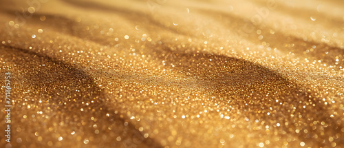 A shimmering fabric of gold and tan, glistening with water droplets, reveals the intricate details of a sandy landscape in a captivating closeup photo
