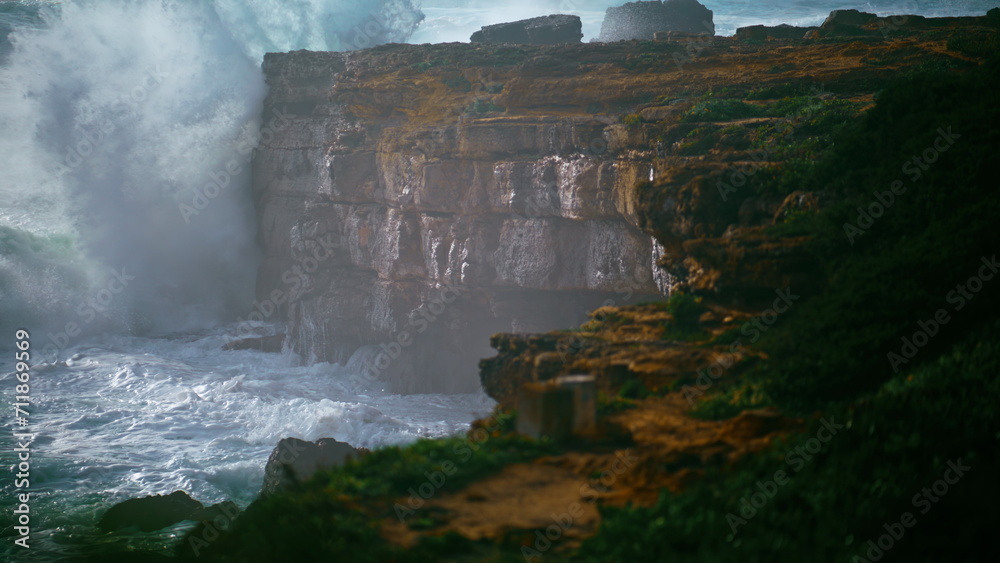 Fototapeta premium Storm surf breaking cliffs in super slow motion. Powerful waves breaking rocky