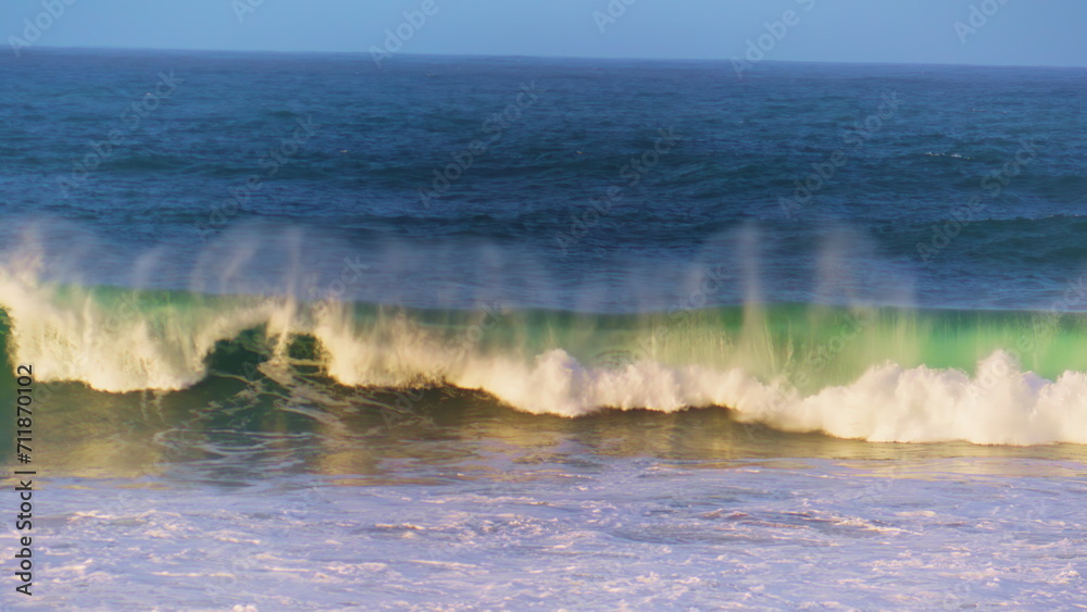 Morning ocean wave rolling towards shallow in super slow motion. White sea foam Morning ocean wave rolling towards shallow in super slow motion. White sea foam