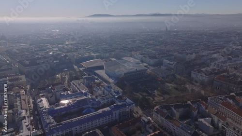 Aerial view of buildings urban borough against sunshine in winter morning haze. Wiener Stadthalle with solar cells on roof. Vienna, Austria photo