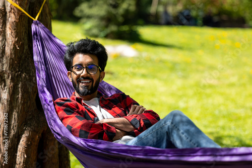 Young hindu man feeling relaxed and happy in the park