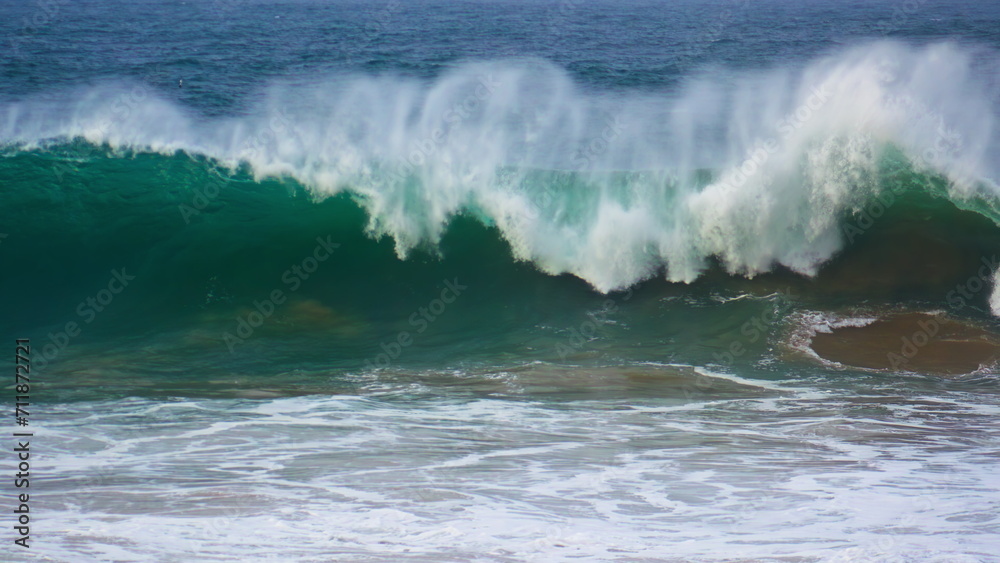 Huge ocean surf barrelling in super slow motion. Powerful wave rolling breaking
