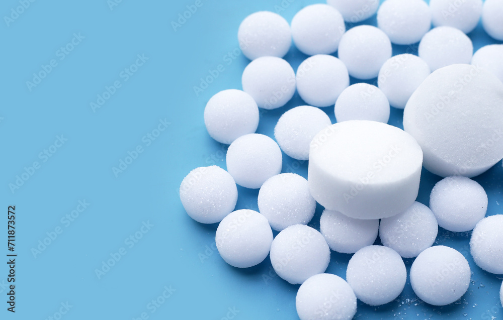 White mothballs on blue background. White mothballs on blue background.
