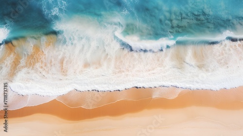 Top down view of ocean waves gently rolling onto the beach,