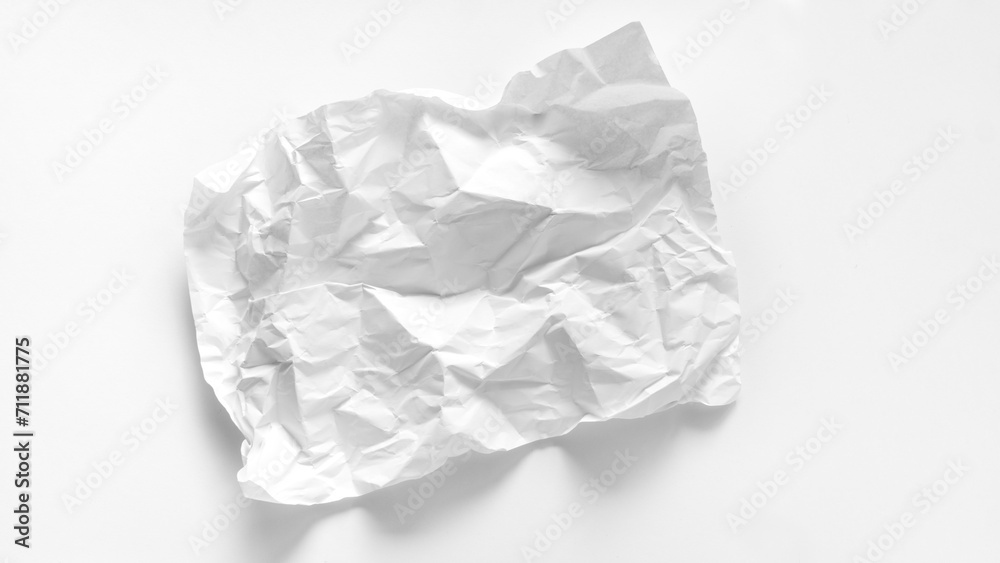 Asymmetrical heavily crumpled sheet of paper close-up on a white background. Crumpled sheet of A4 paper with copy space. Mockup with a crumpled sheet of paper for graphics, words, inscriptions.