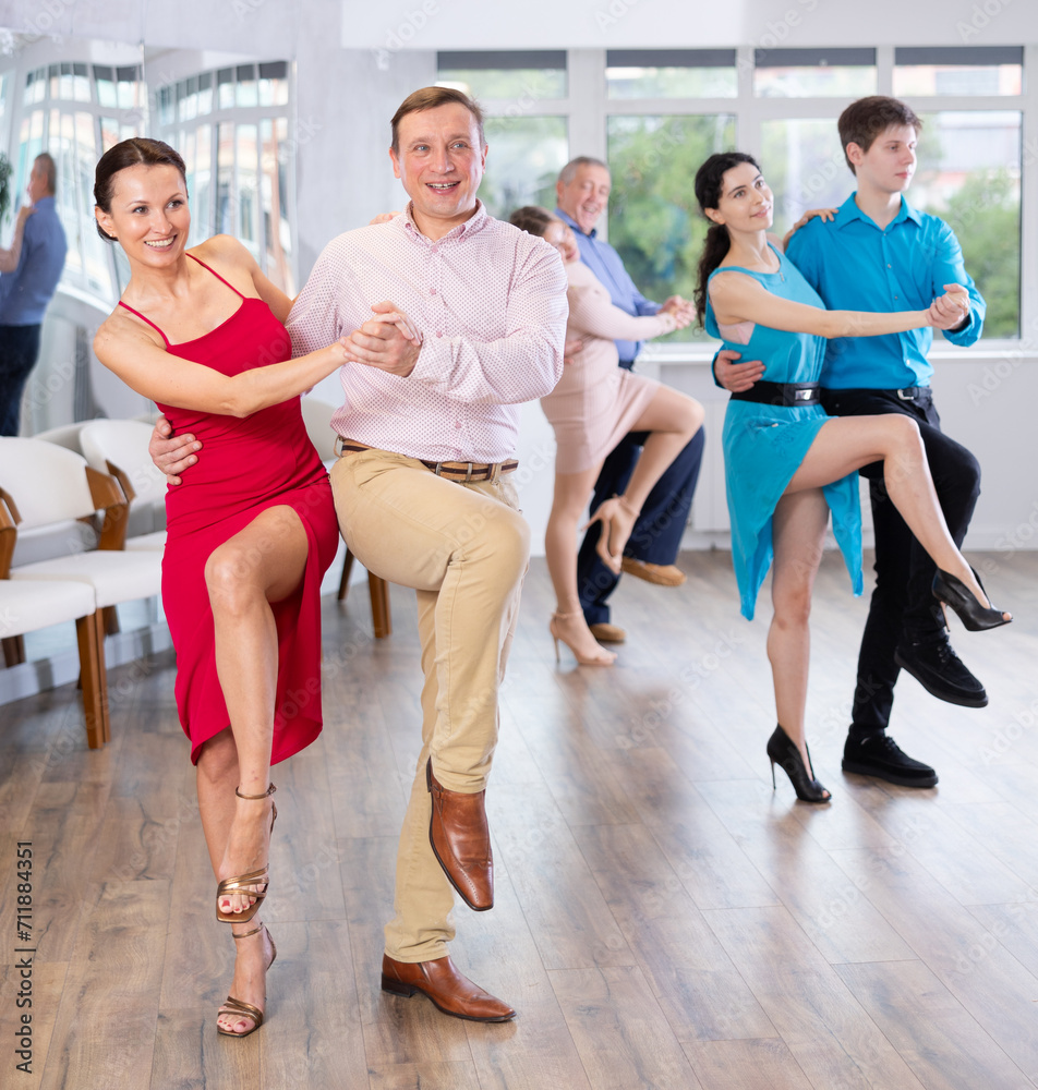 Fototapeta premium Adult couple dancing and practicing in dance class