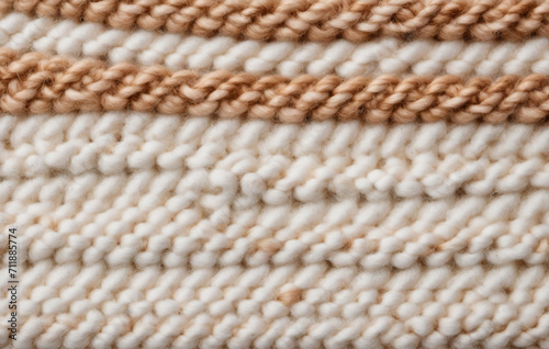 close up of knitted fabric  macro close-up image of a knitted texture  white  cream and brown colors  filling the frame. Idea for sweater or scarf  pattern texture   made by ladies  women  grandmother