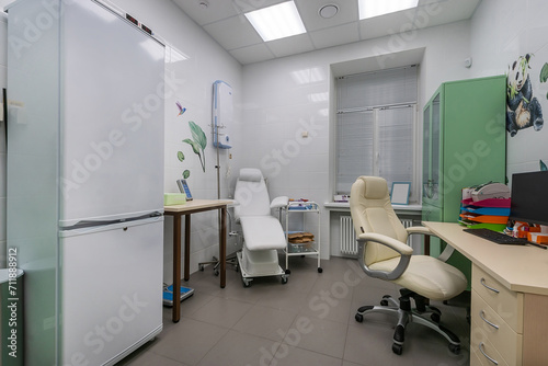 The interior of the office in the children's clinic. Cabinets and a special chair for .inspections. © alhim