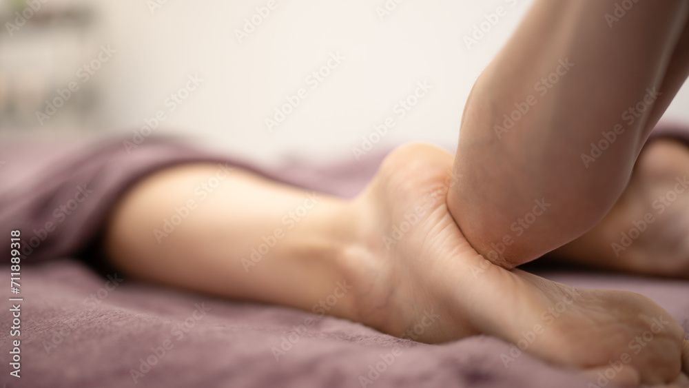 Masseur Providing a Deep Tissue Leg Massage at Spa - obrazy, fototapety, plakaty 