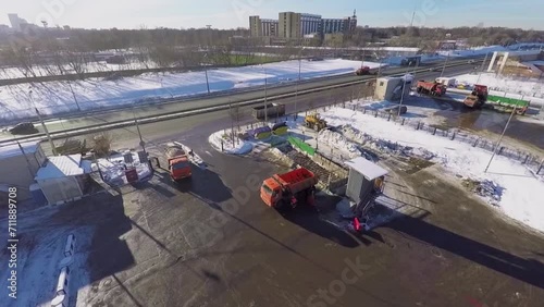 Transport traffic on road near snow melting station at winter photo