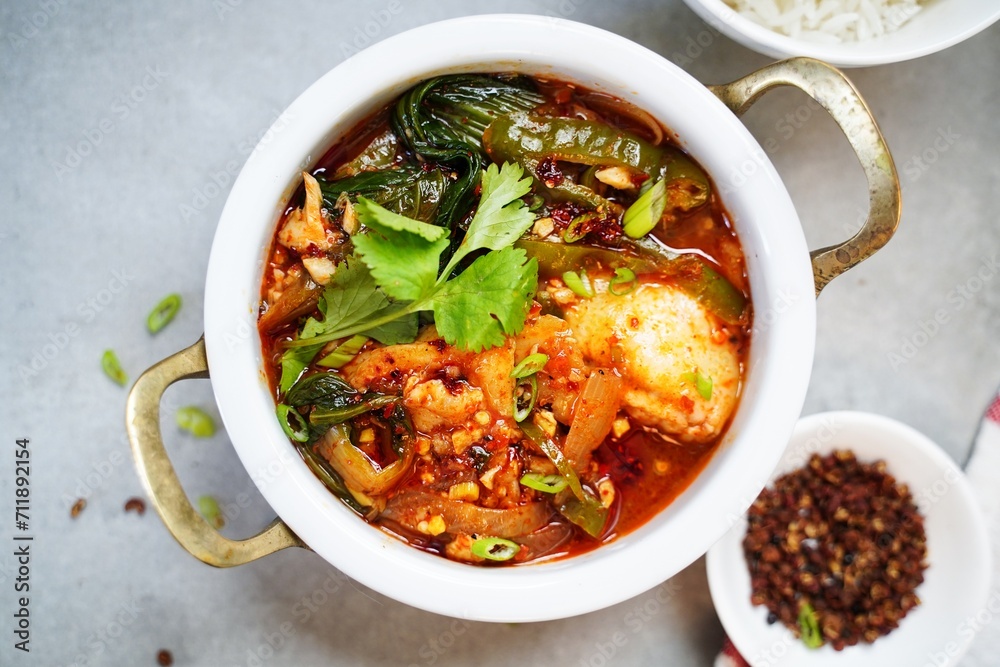 Spicy Chinese style sichuan fish hot pot served with jasmine rice Spicy Chinese style sichuan fish hot pot served with jasmine rice