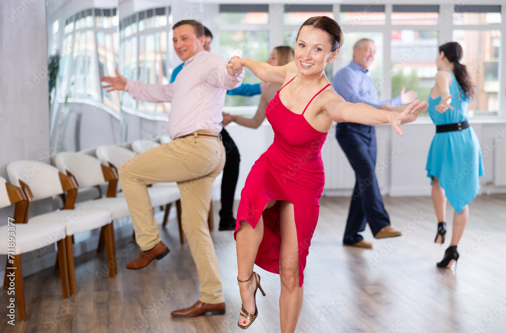 Fototapeta premium Adult couple dancing and practicing in dance class