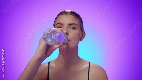 Female drinking water from plastic bottle 