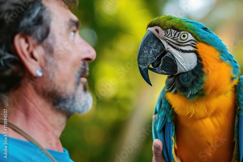 A colorful macaw perches on the shoulder of a man, their feathers blending seamlessly as they enjoy the warm outdoor breeze together
