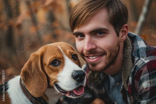 A proud beagle owner captures a moment of pure joy as he and his faithful companion strike a pose in the great outdoors, both sporting matching collars and radiant smiles