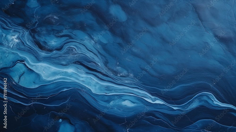 Abstract marble texture with gray and blue interspersed on a dark background