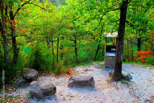 Intriguing scenery from Lago di Boccafornace in Pievebovigliana, Valfornace (Macerata), a little refuge near the woods by the lake with a barbecue, a thick trunk and four huge stones serving as seats