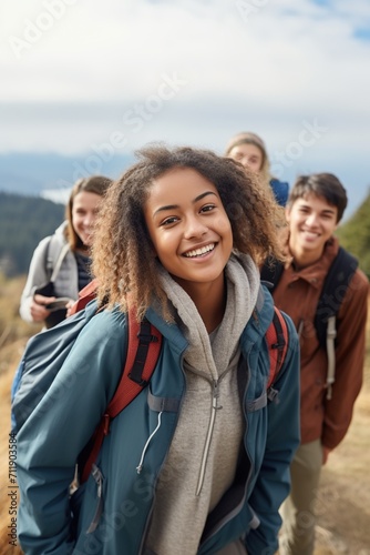 Multiethnic group of teenage friends hiking in the mountains