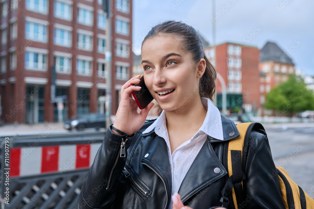 Young attractive teenage girl talking on mobile phone, outdoor Young attractive teenage girl talking on mobile phone, outdoor